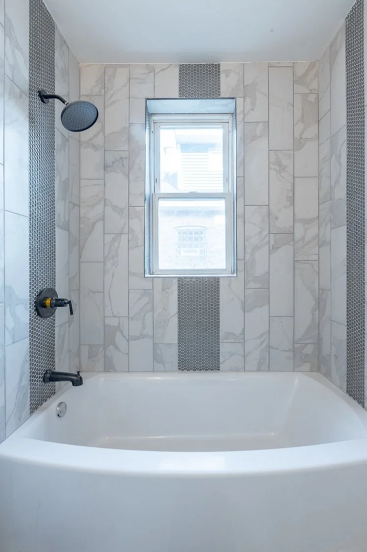 Bathroom with a tub and shower