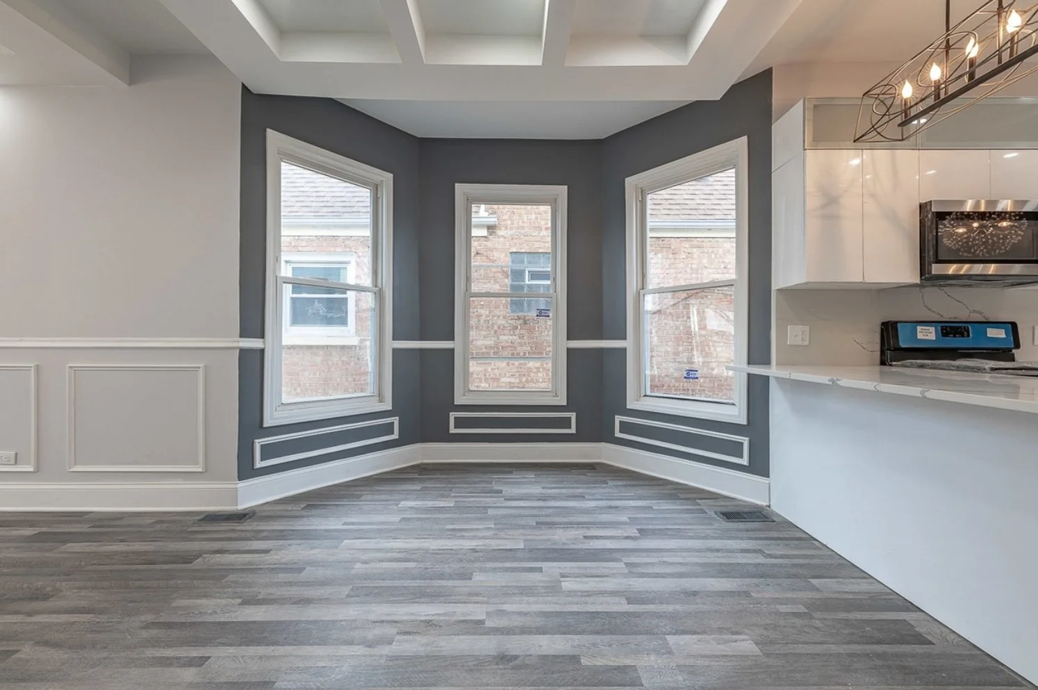 Breakfast nook framed by bay windows