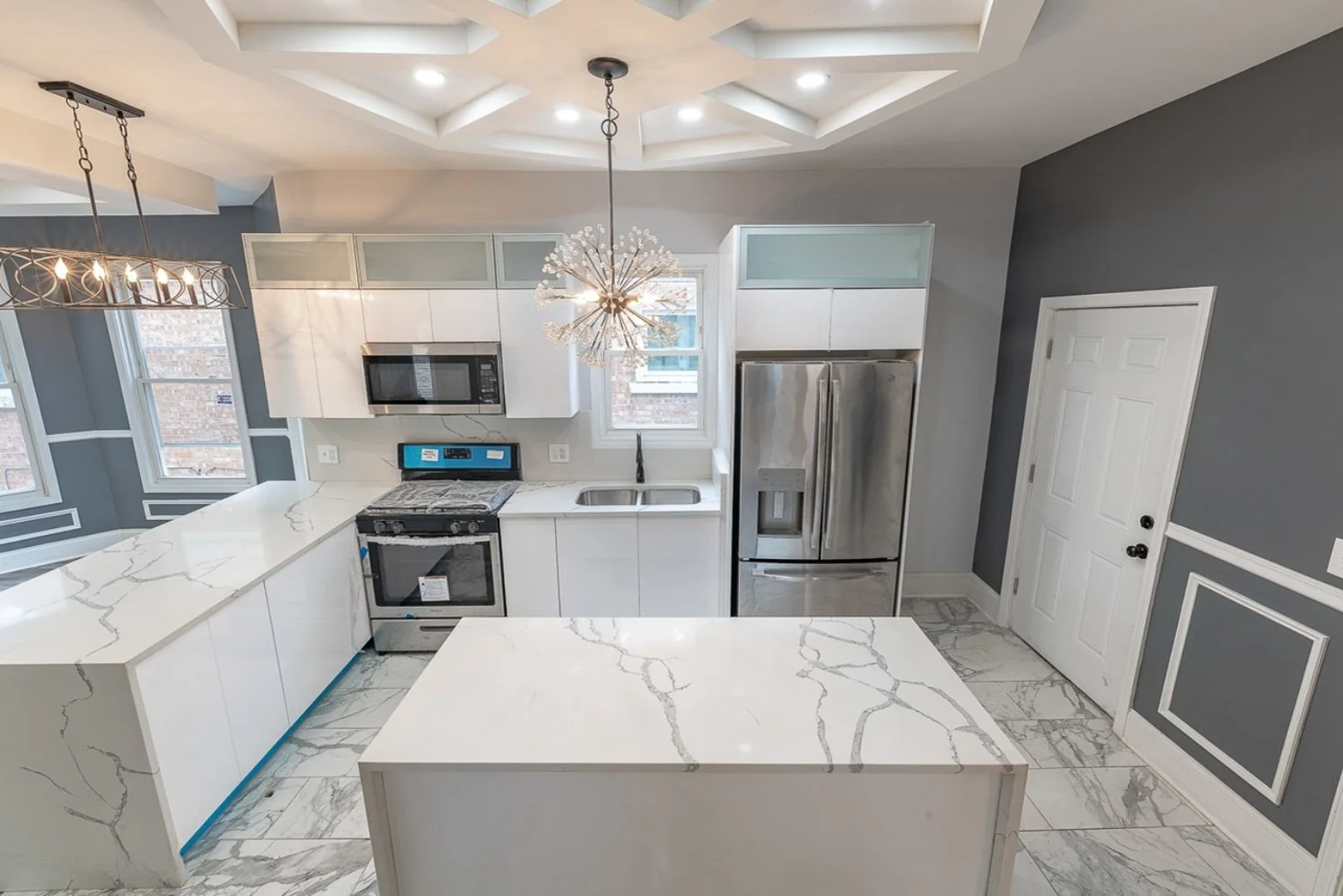 Remodeled white shaker kitchen with quartz counters