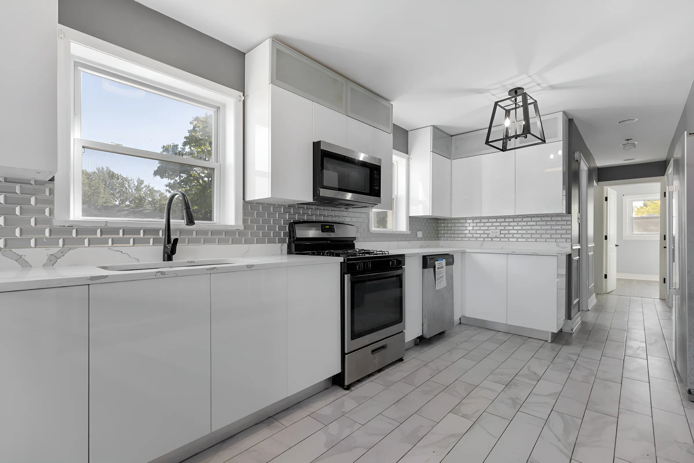 Kitchen with stainless appliances and brass hardware